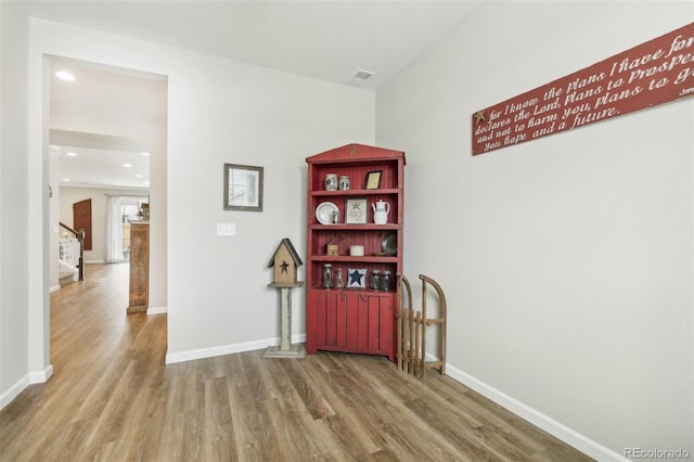 interior space featuring recessed lighting, wood finished floors, visible vents, and baseboards