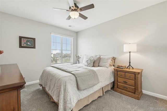 bedroom featuring visible vents, baseboards, a ceiling fan, and light colored carpet