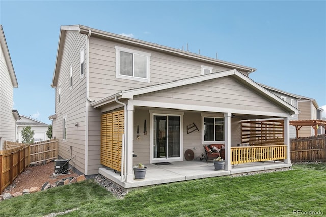 back of property with a patio area, a fenced backyard, a lawn, and central AC unit