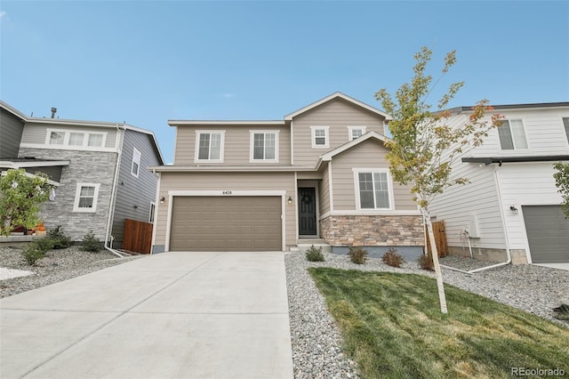 view of front facade featuring a front yard, stone siding, driveway, and fence