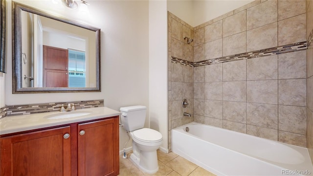 full bathroom featuring tile patterned flooring, vanity, toilet, and tiled shower / bath combo