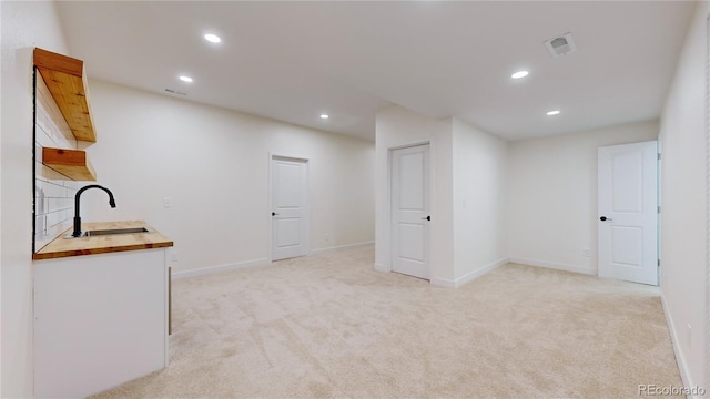 interior space with light colored carpet and sink