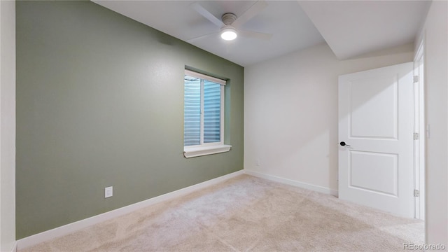 carpeted empty room featuring ceiling fan