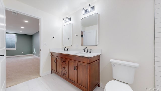 bathroom with tile patterned floors, vanity, and toilet