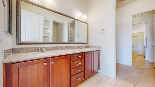 bathroom featuring tile patterned flooring and vanity