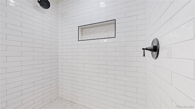 bathroom with a tile shower