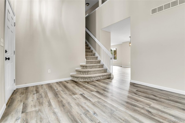 22974 E Dorado Dr, Aurora, CO 80015 - foyer entrance with wood finished floors, stairs, baseboards, and a high ceiling