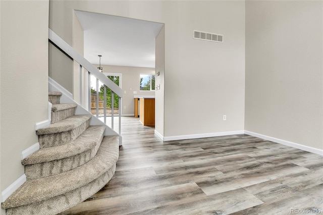 22974 E Dorado Dr, Aurora, CO 80015 - staircase featuring wood finished floors, baseboards, and a chandelier