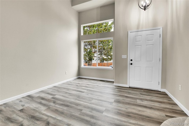 22974 E Dorado Dr, Aurora, CO 80015 - foyer entrance with a towering ceiling, baseboards, and wood finished floors