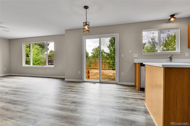 22974 E Dorado Dr, Aurora, CO 80015 - unfurnished dining area featuring light wood-type flooring and baseboards