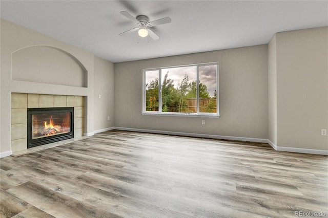 22974 E Dorado Dr, Aurora, CO 80015 - unfurnished living room featuring ceiling fan, baseboards, wood finished floors, and a tile fireplace