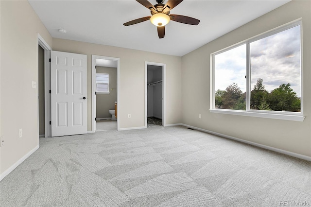 22974 E Dorado Dr, Aurora, CO 80015 - unfurnished bedroom with carpet floors, multiple windows, a walk in closet, and baseboards