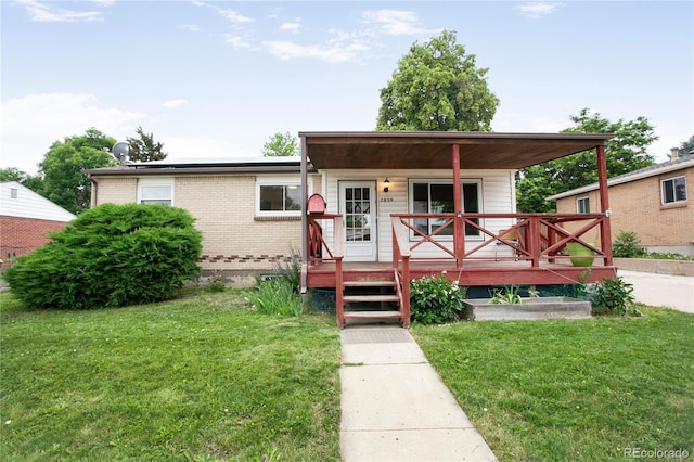 7839 Florado St, Denver, CO 80221 - view of front of house featuring a front yard and brick siding
