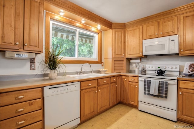 7839 Florado St, Denver, CO 80221 - kitchen featuring white appliances, light floors, brown cabinetry, and light countertops