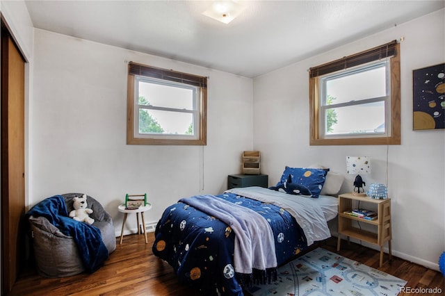 7839 Florado St, Denver, CO 80221 - bedroom featuring multiple windows and wood finished floors