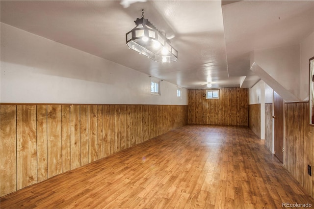 7839 Florado St, Denver, CO 80221 - additional living space with wood walls, wood finished floors, and wainscoting
