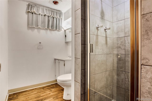 7839 Florado St, Denver, CO 80221 - bathroom with a stall shower, wood finished floors, and vanity