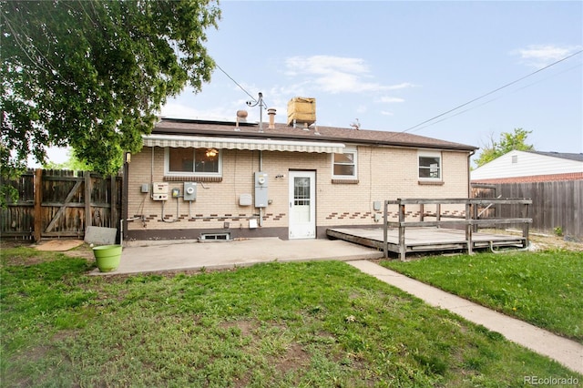 7839 Florado St, Denver, CO 80221 - rear view of property featuring a deck, brick siding, a chimney, a patio area, and a gate