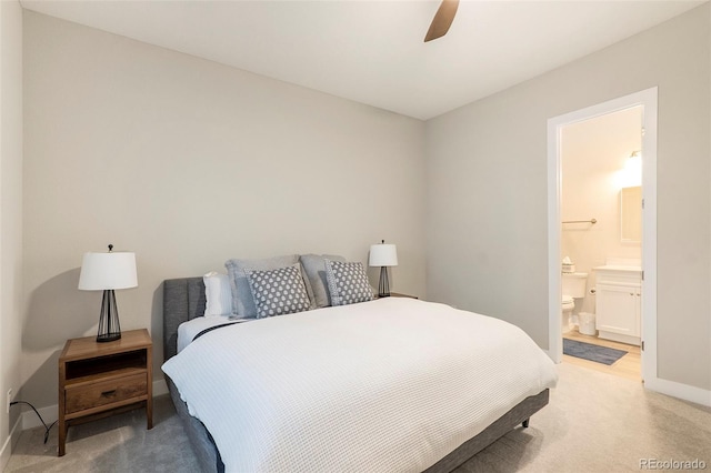 carpeted bedroom featuring connected bathroom and ceiling fan