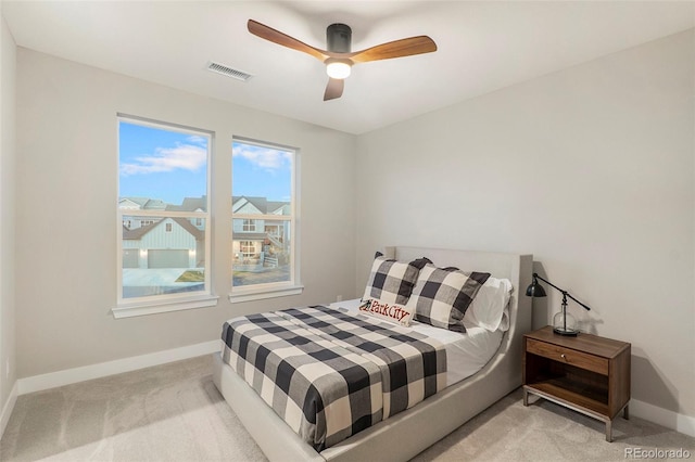 bedroom with light carpet and ceiling fan