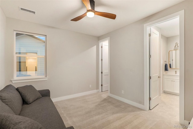 carpeted living room featuring ceiling fan