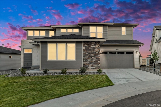 view of front of property featuring a yard and a garage