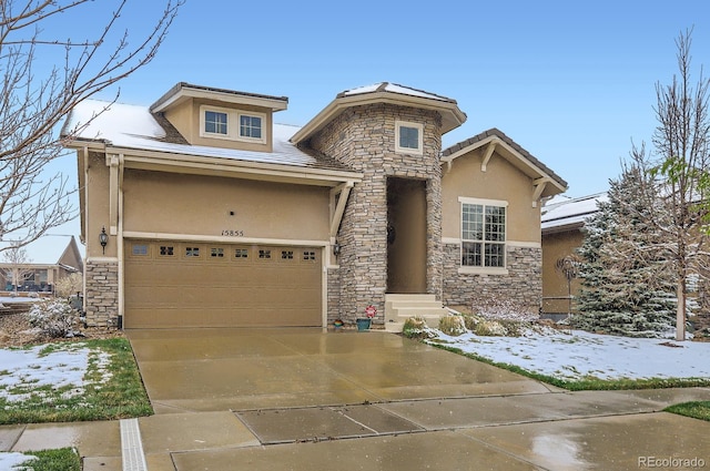 15855 Wild Horse Dr, Broomfield, CO 80023 - view of front facade featuring stucco siding, an attached garage, driveway, and stone siding