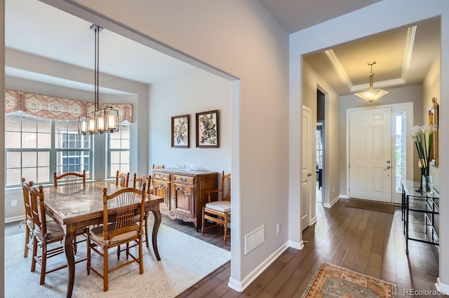 15855 Wild Horse Dr, Broomfield, CO 80023 - dining room featuring an inviting chandelier, a raised ceiling, baseboards, dark wood-style flooring, and visible vents