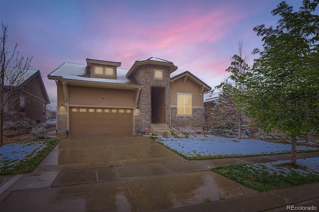 15855 Wild Horse Dr, Broomfield, CO 80023 - view of front facade featuring stucco siding, driveway, stone siding, and a garage