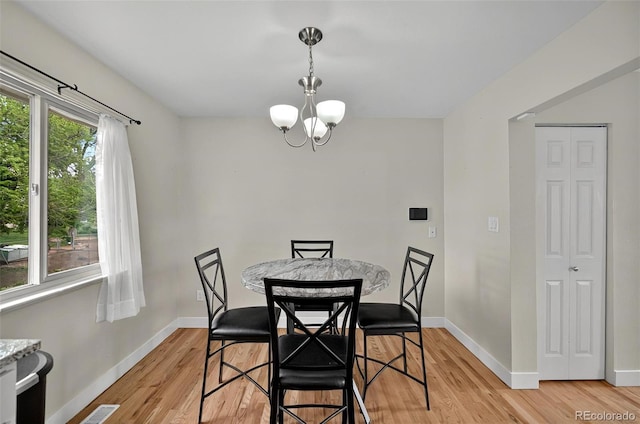 196 Jersey, Colorado Springs, CO 80911 - dining area with a chandelier, light wood-type flooring, and baseboards
