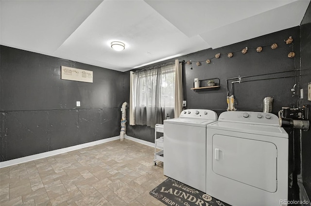 196 Jersey, Colorado Springs, CO 80911 - laundry room featuring washer and clothes dryer, stone finish flooring, and baseboards