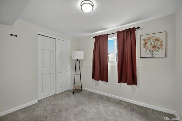 196 Jersey, Colorado Springs, CO 80911 - unfurnished bedroom featuring carpet flooring, a closet, baseboards, and a textured ceiling