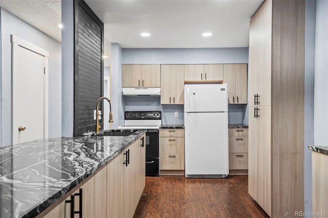 kitchen featuring dark stone counters, white appliances, sink, and dark hardwood / wood-style flooring