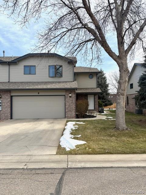 front facade with a front yard and a garage