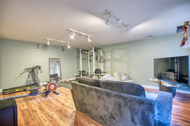 interior space featuring dark hardwood / wood-style floors and track lighting