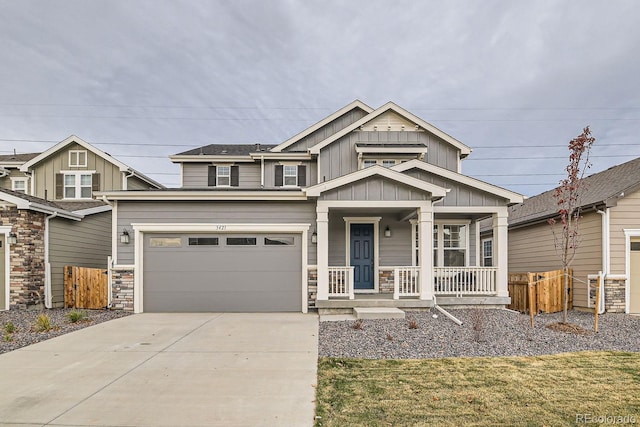 craftsman inspired home with a front yard, a porch, and a garage