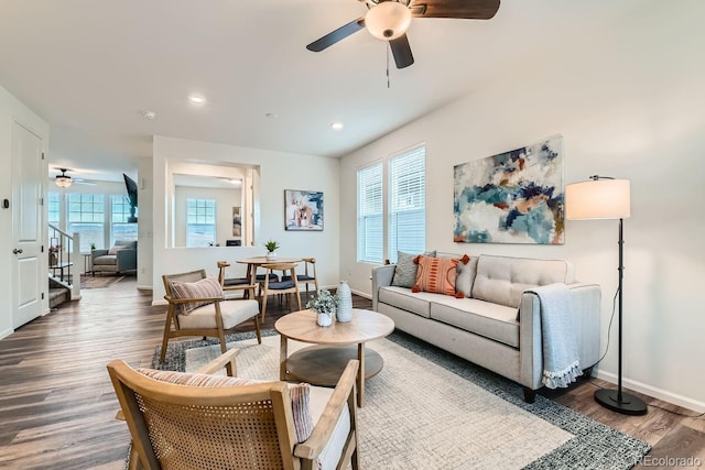 living room with plenty of natural light, ceiling fan, and dark hardwood / wood-style flooring