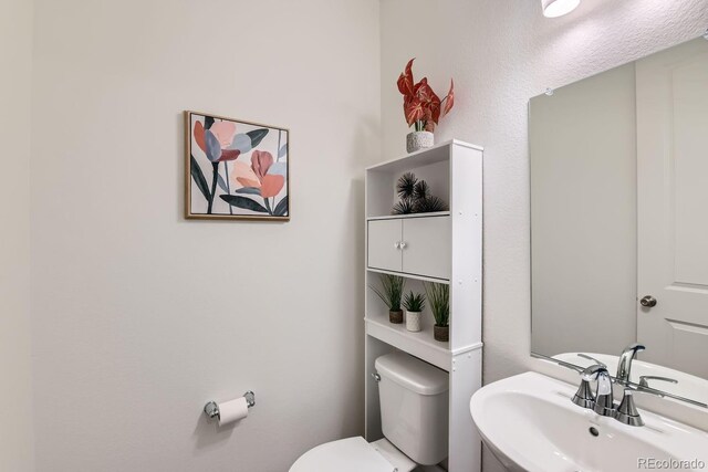 bathroom with sink and toilet