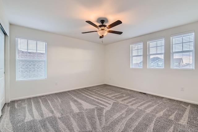 carpeted empty room with ceiling fan