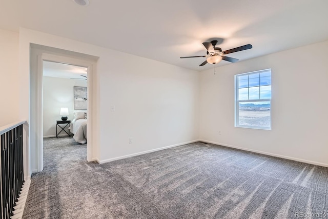 spare room with ceiling fan and carpet floors