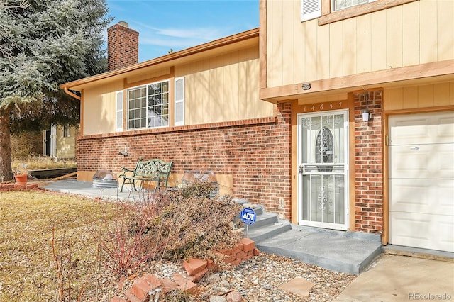 view of exterior entry with a garage