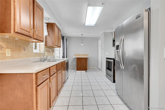 kitchen featuring stainless steel appliances, decorative backsplash, sink, hanging light fixtures, and light tile patterned floors