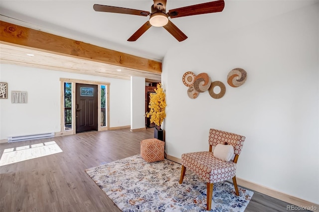 sitting room with ceiling fan, a baseboard heating unit, hardwood / wood-style floors, and beam ceiling