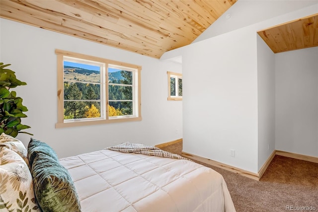 carpeted bedroom featuring vaulted ceiling and wooden ceiling