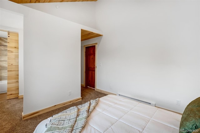 carpeted empty room with a baseboard radiator and vaulted ceiling