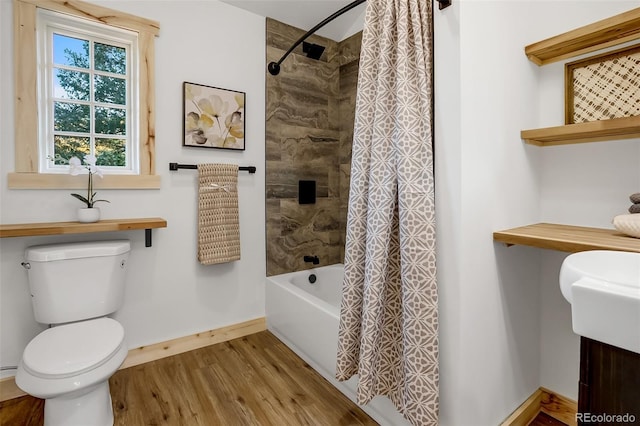 bathroom with wood-type flooring, toilet, and shower / bath combo