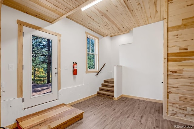 foyer entrance with wood ceiling and light hardwood / wood-style floors