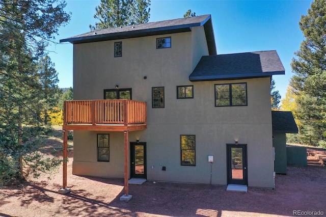 back of property with a balcony