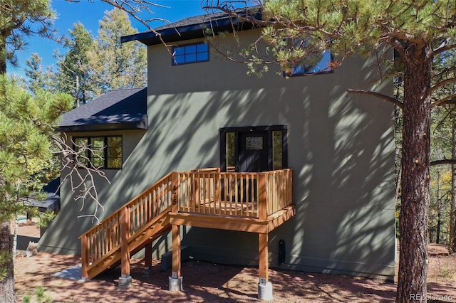 back of property with a wooden deck