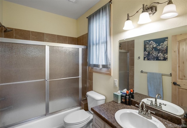 full bathroom with shower / bath combination with glass door, vanity, and toilet